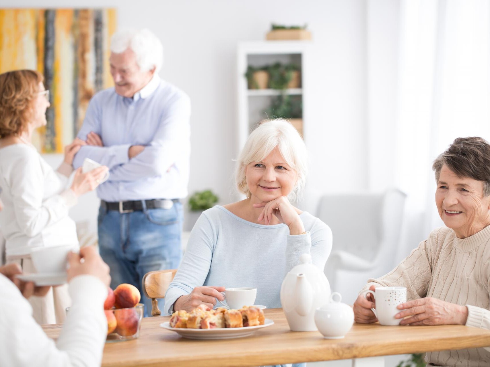 Elderly care home residents in dining room