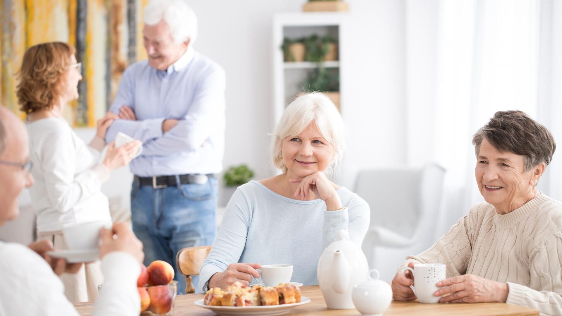 Elderly care home residents in dining room