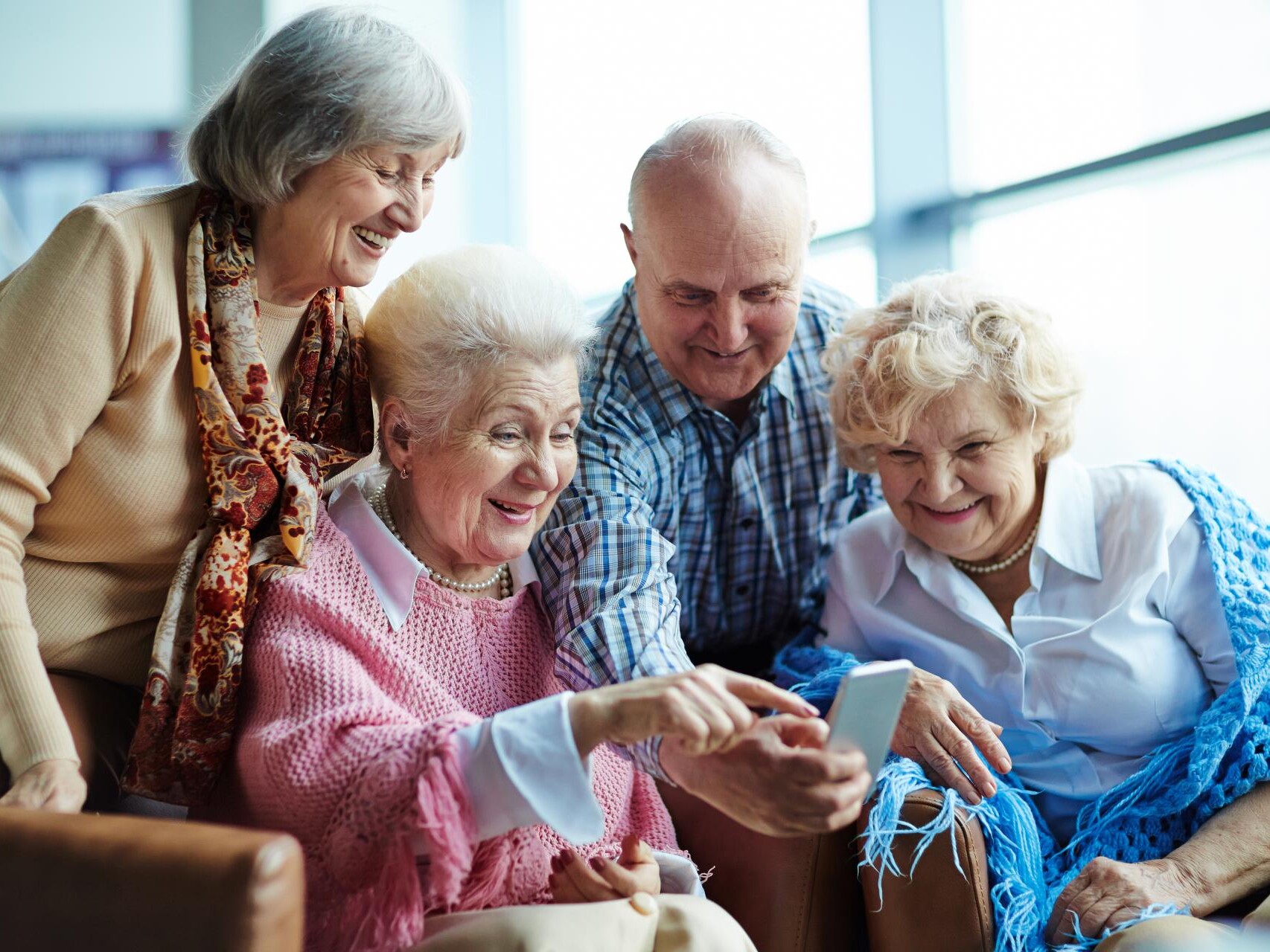 Group of elderly residents enjoying their care home