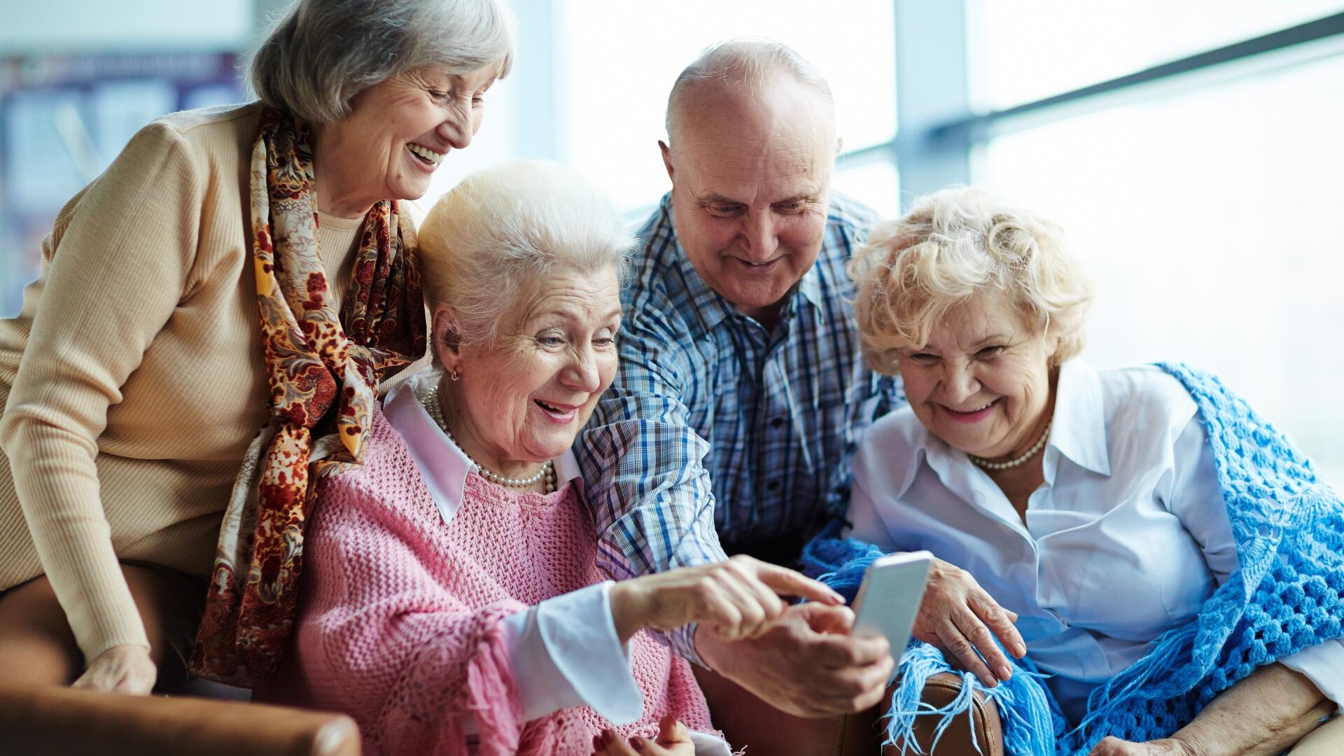 Group of elderly residents enjoying their care home